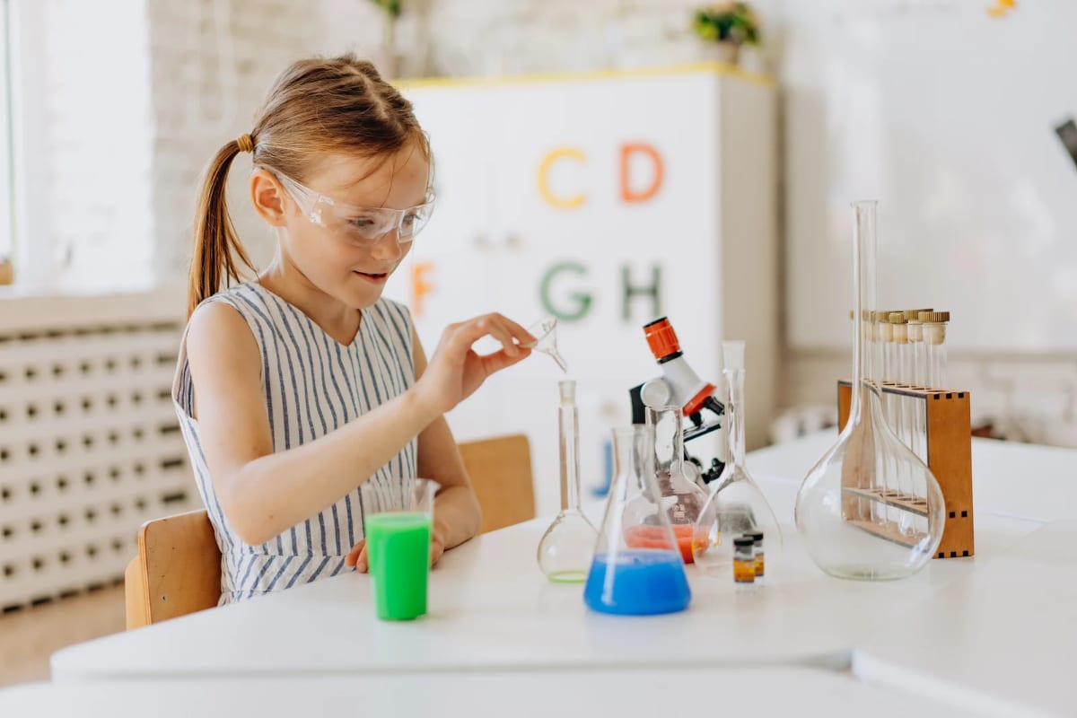 A student running a science experiment in a bright classroom
